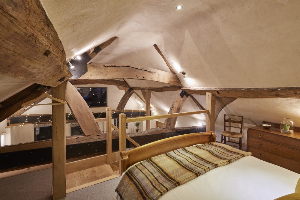 The view across the vaulted oak-beamed ceiling, from the master bedroom