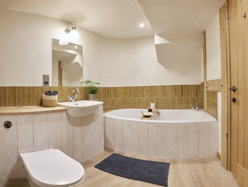 The ensuite bathroom showing the bath, sink and toilet