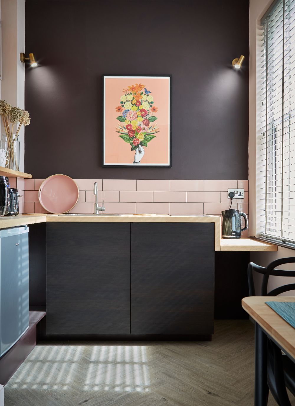 A view directly into the kitchenette showing the vivid colour scheme